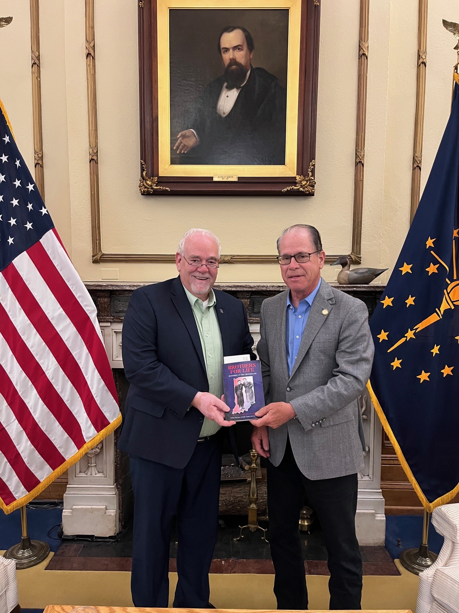 Read more about the article Governor Braun of Indiana being presented with a copy of Brothers for Life in Indiana State Capital Building